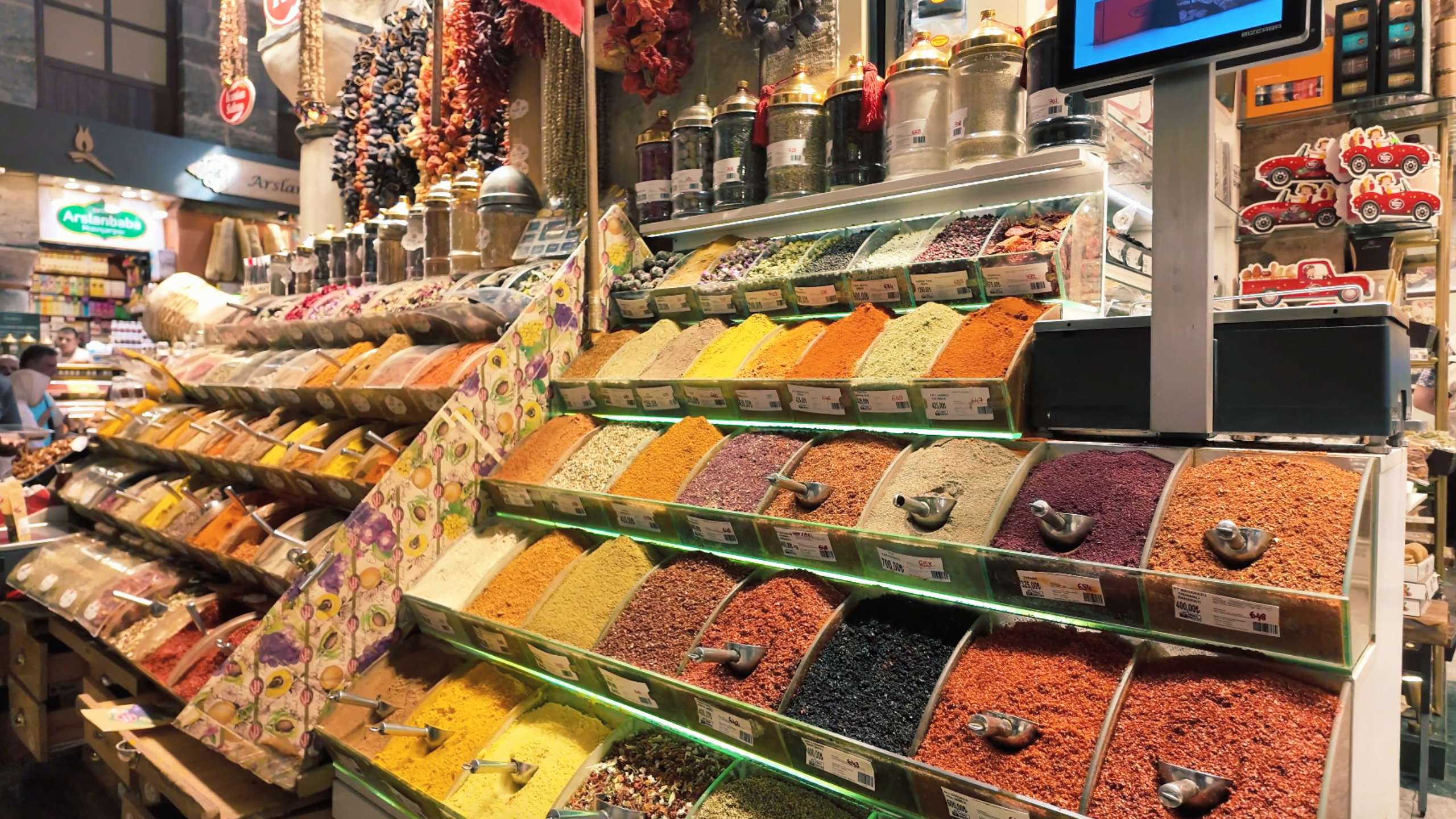 A vibrant spice display with shelves of colorful powders and dried herbs.