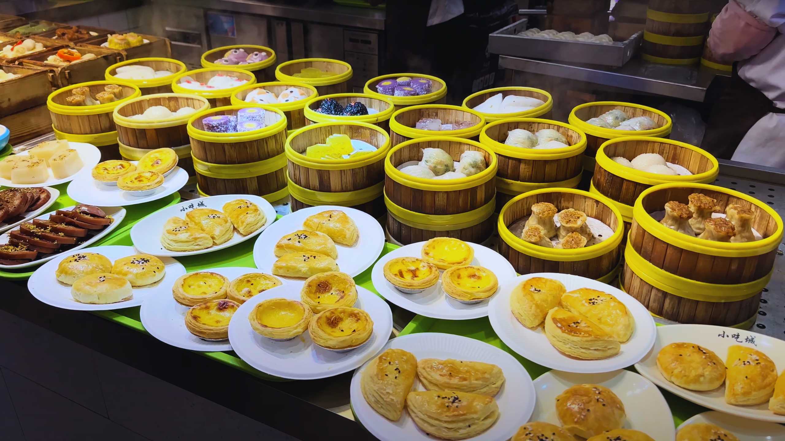 Assorted dim sum baskets filled with various steamed delicacies.