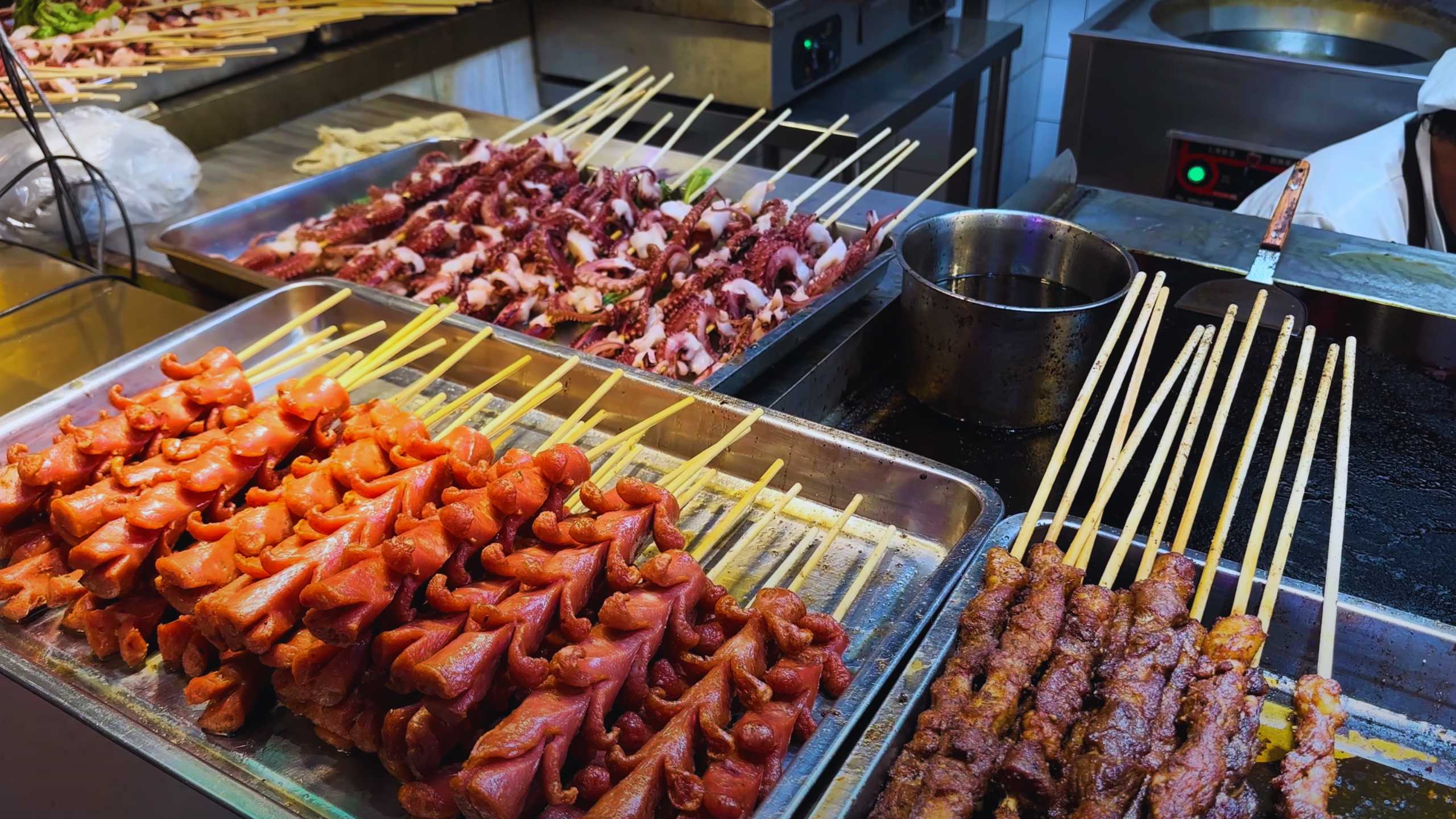 Skewers of octopus and sausage ready for grilling.