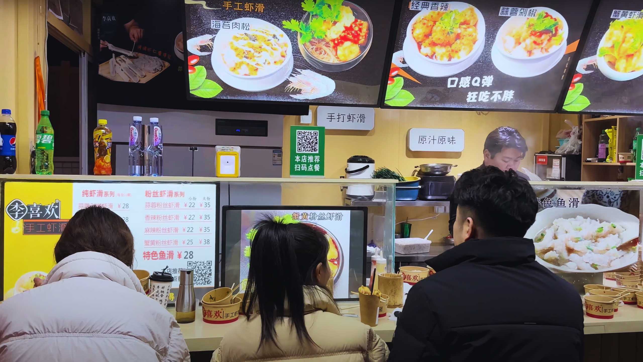 Customers wait in line to order steaming bowls of noodle soup.