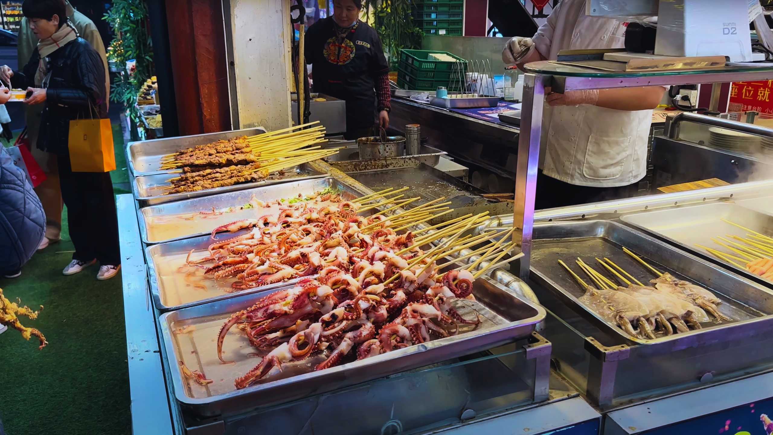 Fresh seafood skewers sizzling on a hot grill for hungry patrons.