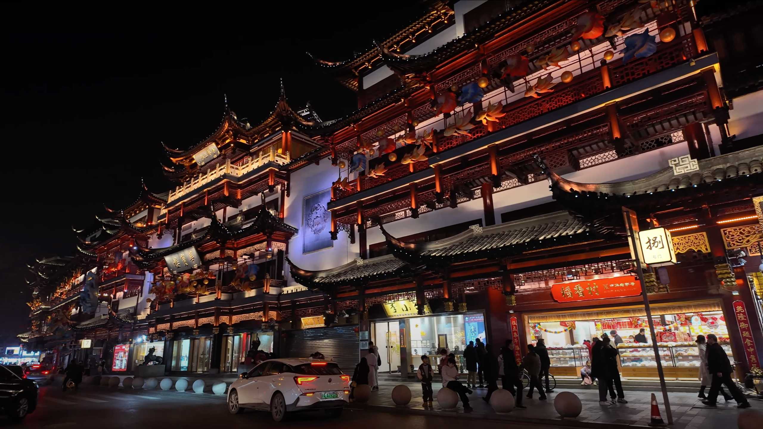 Night view of traditional buildings with red lanterns.