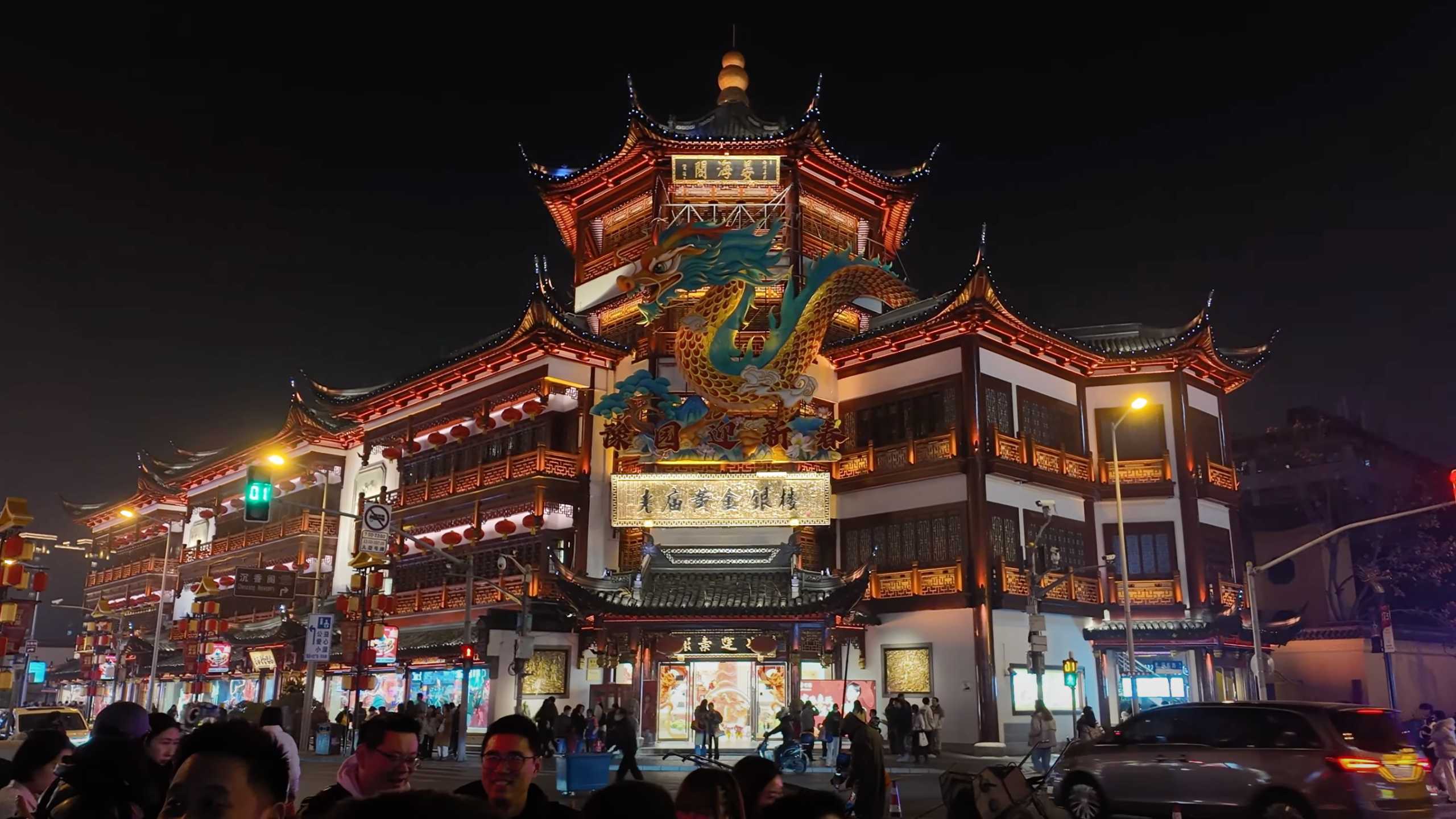 Vibrant dragon sculpture gracing the ornate facade of an ancient building.