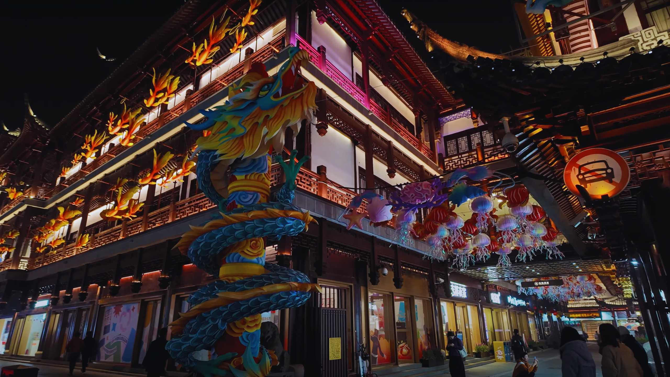 Colorful dragon sculpture winding around a traditional building.