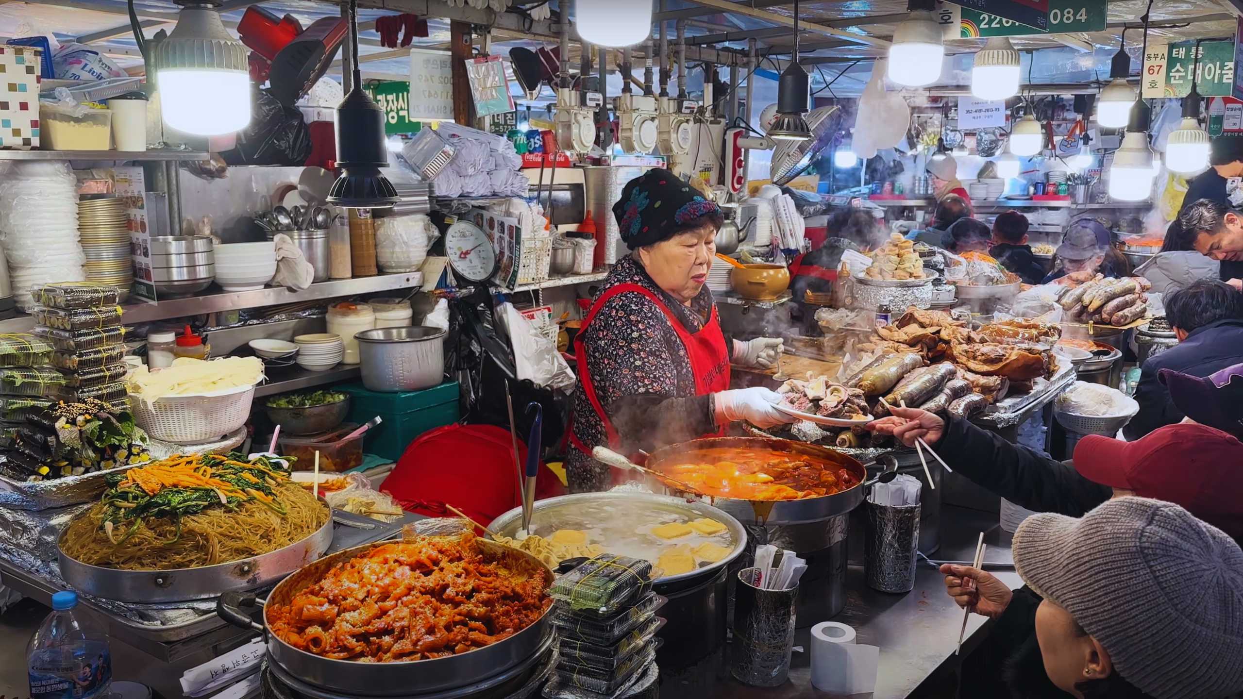 Steaming bowls of tteokbokki and freshly prepared gimbap ready for eager customers.