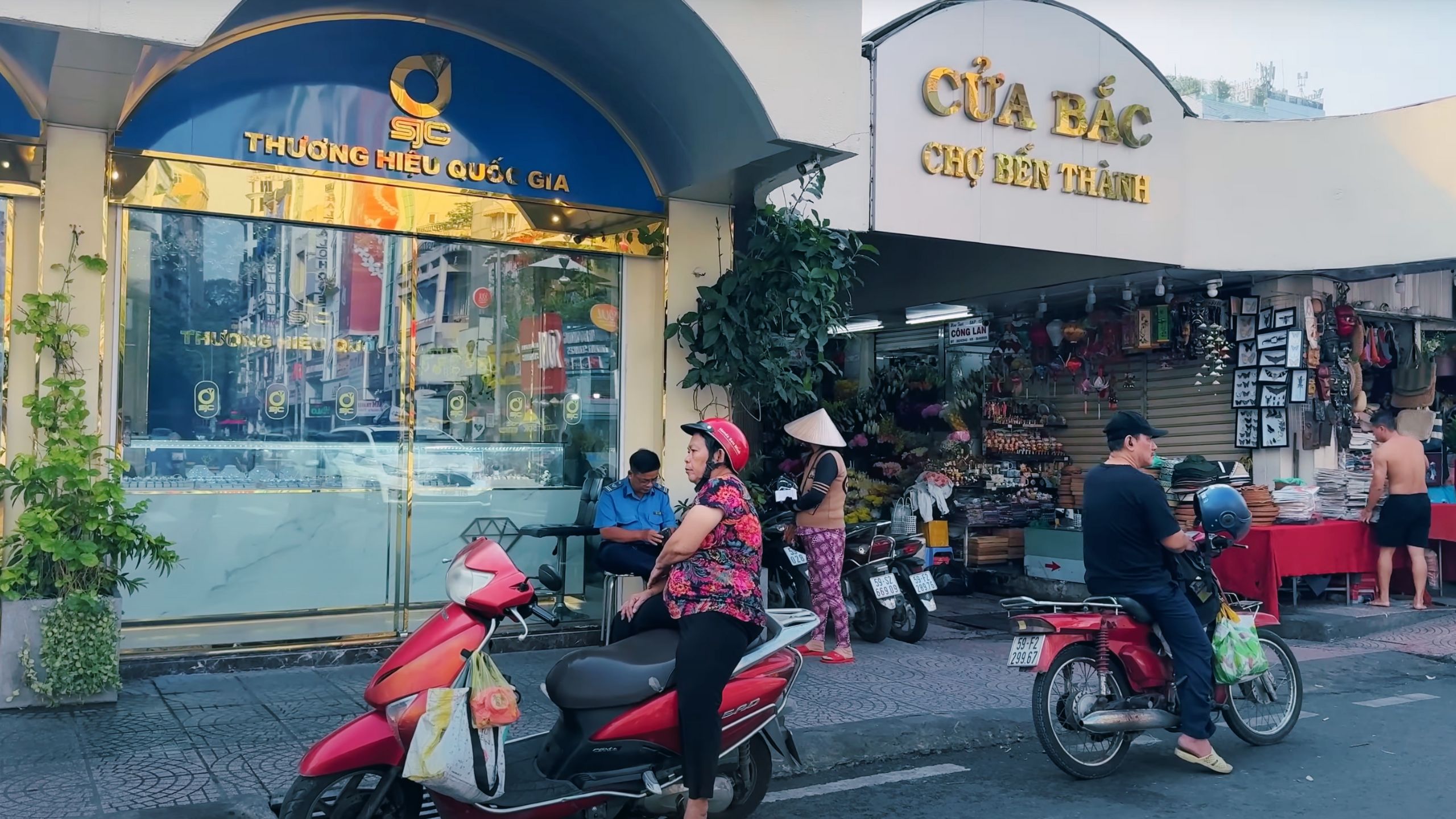 Locals gather at the Ben Thanh Market entrance, a bustling hub in Ho Chi Minh City.