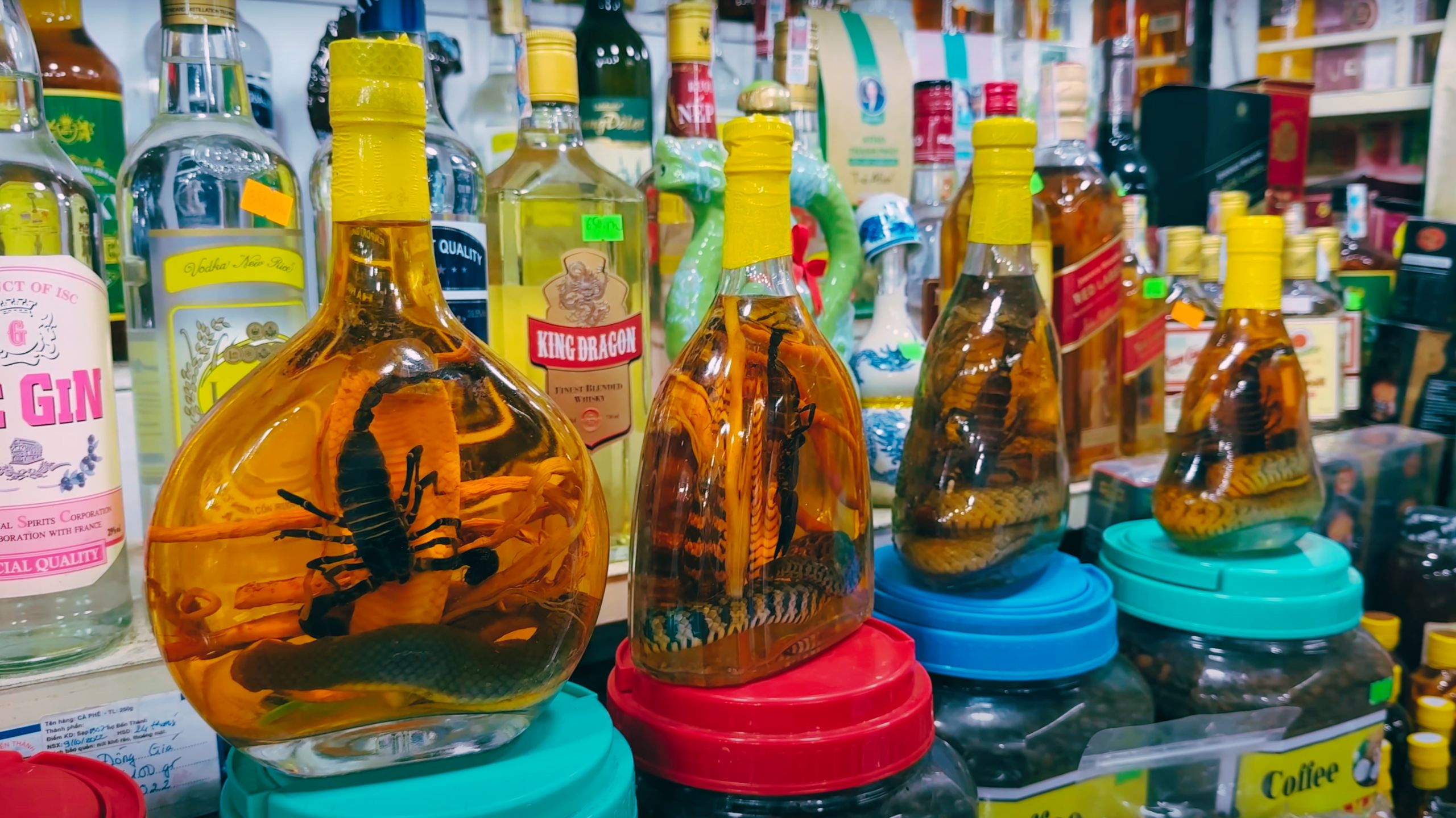 Exotic rice wines with snakes and scorpions in bottles, a unique market curiosity.