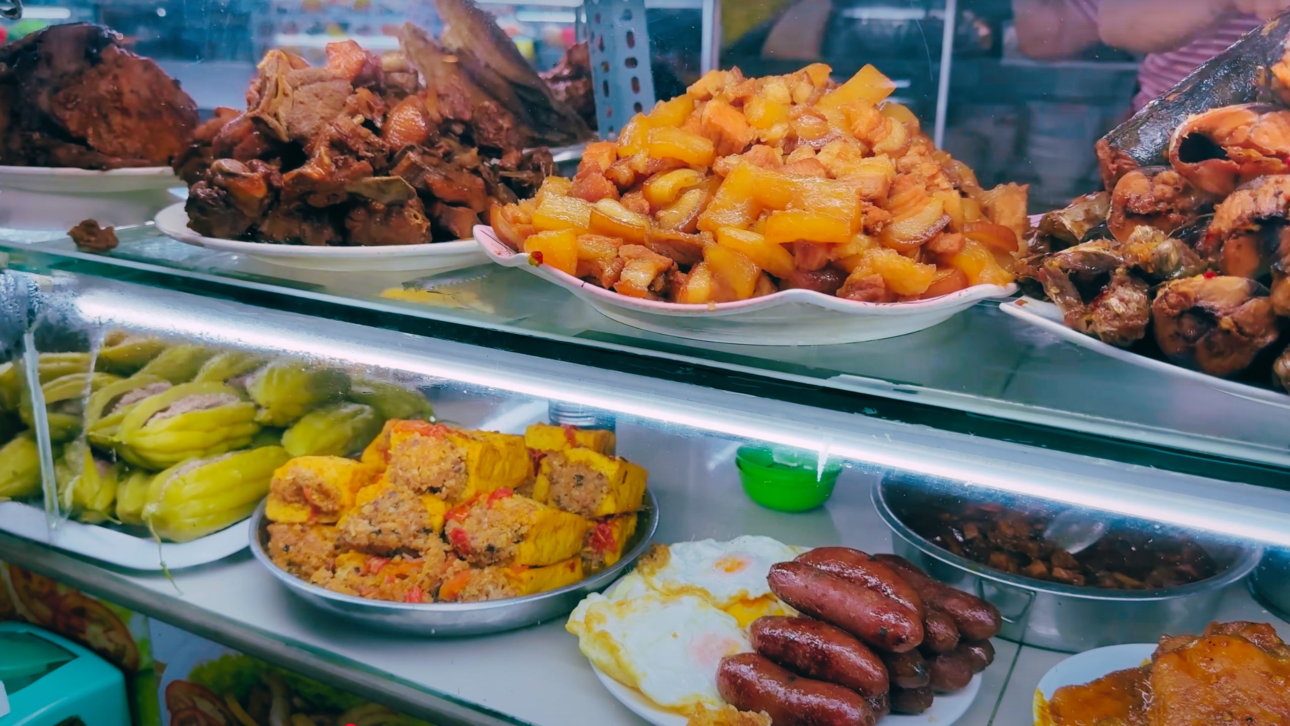 Variety of traditional Vietnamese cooked dishes, from sausages to stewed meats and eggs.