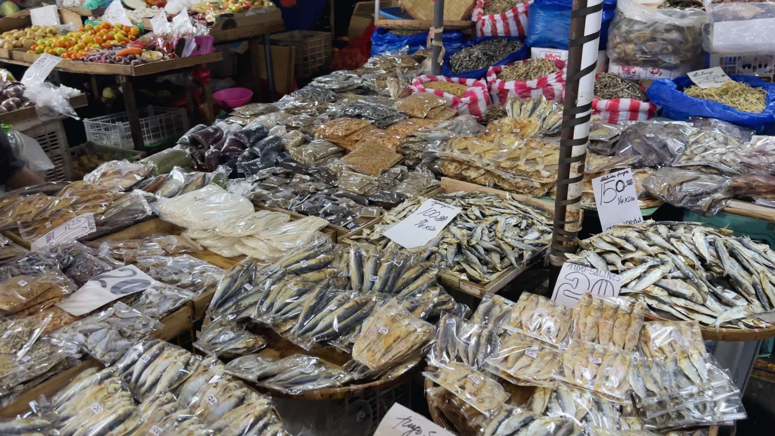 A large assortment of dried fish and seafood, neatly packed and arranged for sale.