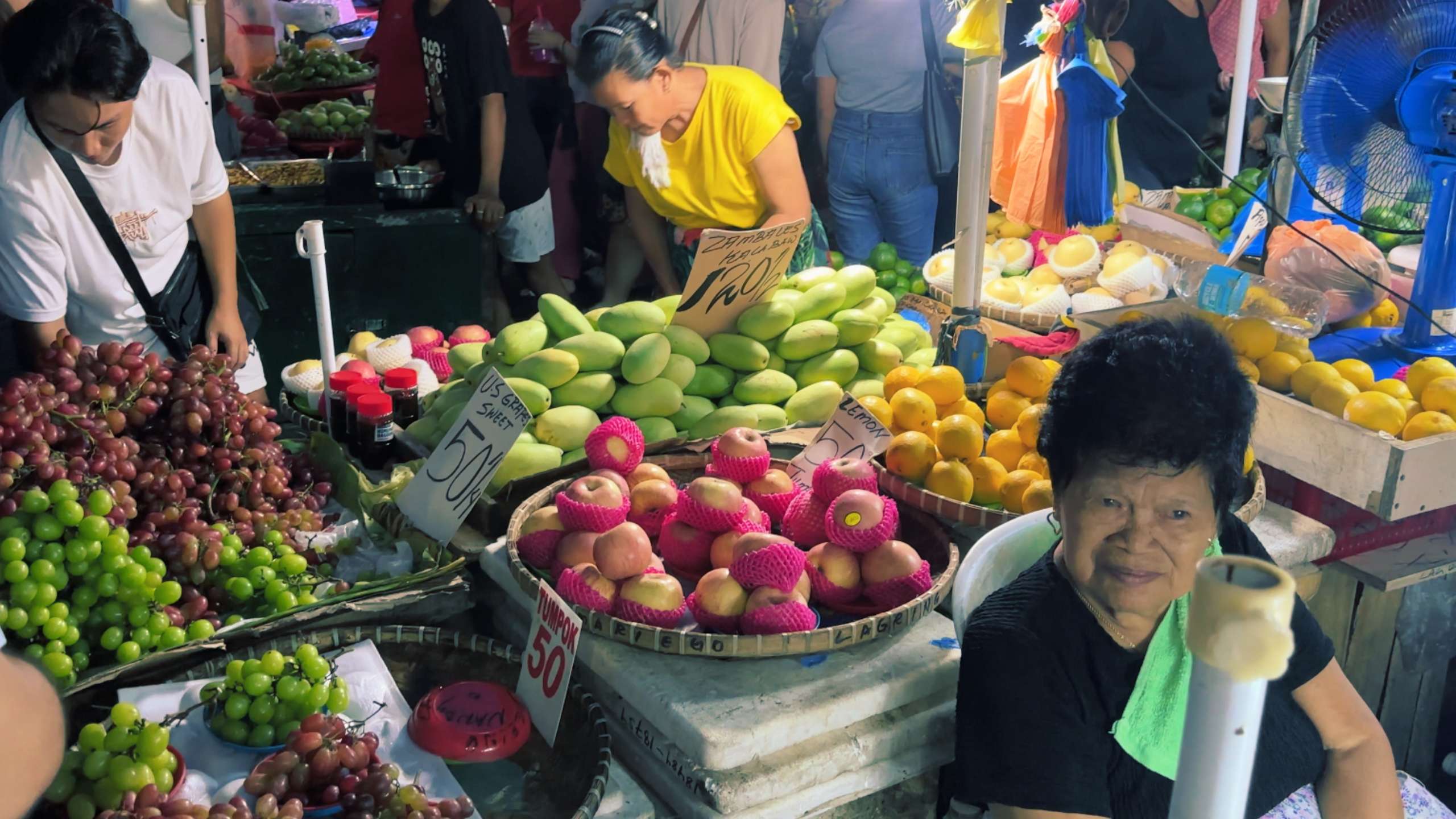 Stacks of fresh fruits and vegetables on display, attracting eager shoppers.